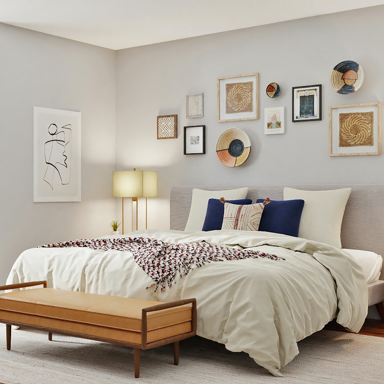 A bedroom with bed, bench at the foot of the bed and hanged art above and beside the bed.