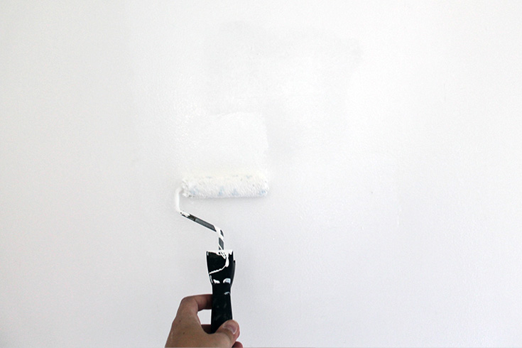 Painting after patching a small hole in a wall at home.