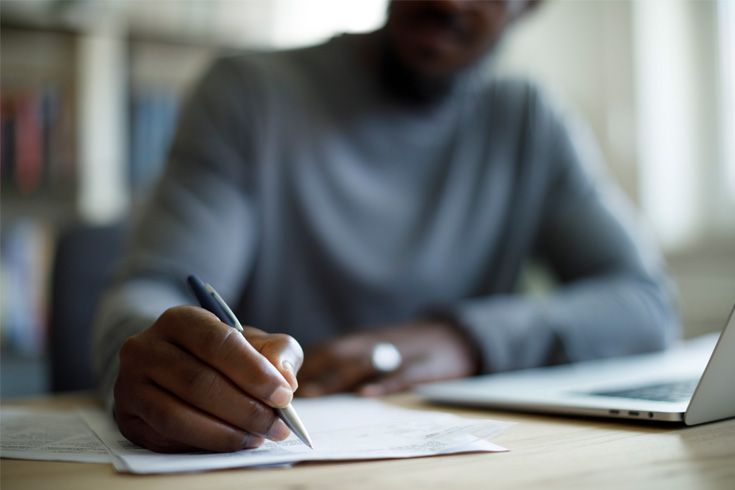 Male signing legal documents for new home purchase