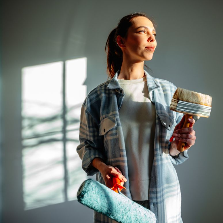 Woman holding paint supplies