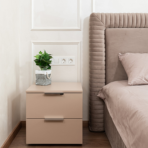 Stylish interior of bedroom in modern apartment, empty wall outlets.