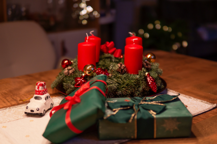 Holiday wreath on table with candles