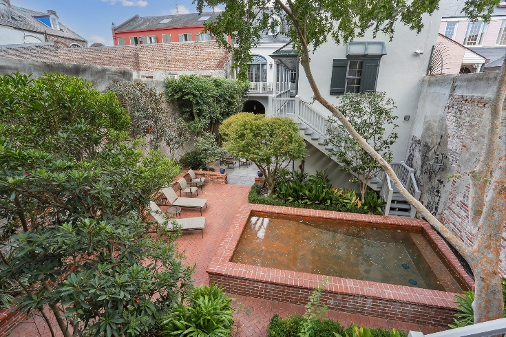 An inner courtyard, with a fountain, pool and landscaped grounds.