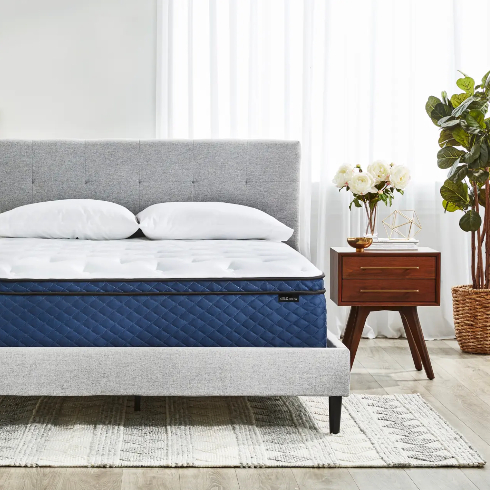 A luxurious Silk and Snow mattress in a neutral grey bedroom