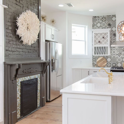 Masters of Flip bohemian Victorian house kitchen grey brick fireplace with large feather wreath above the painted mantel