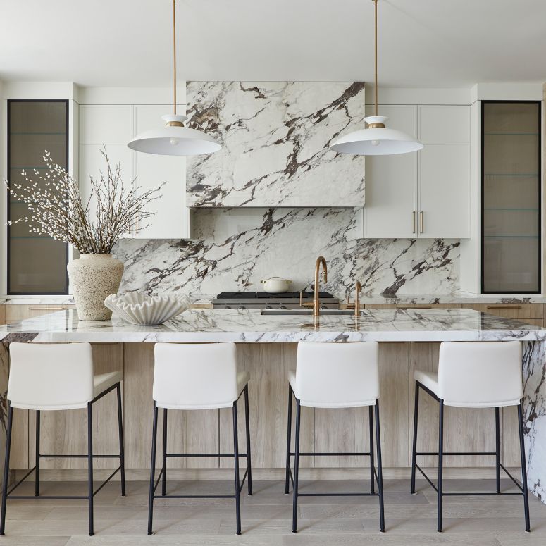 Marble backsplash and hood vent in kitchen