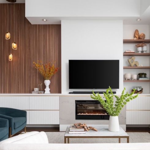 Living room with fireplace and wood wall