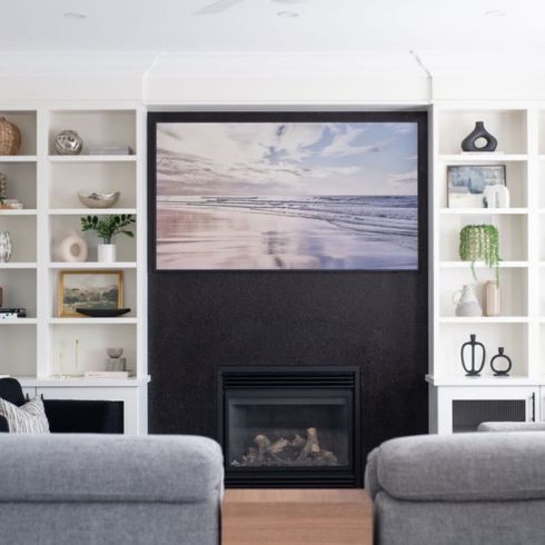 Fireplace with flanking open shelving