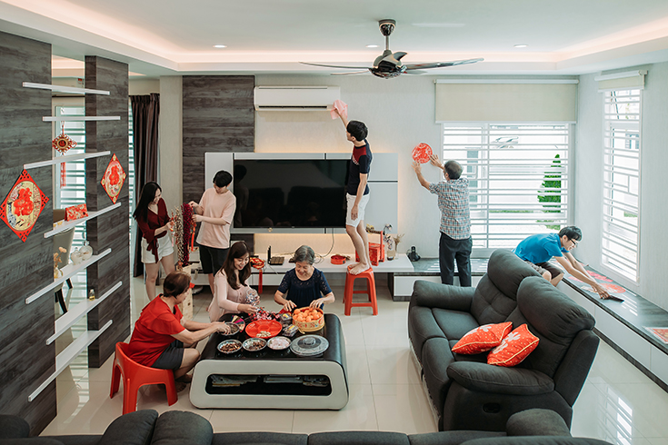 wide shot of peoples decorating, adjusting, arranging, hanging and cleaning during Chinese new year eve