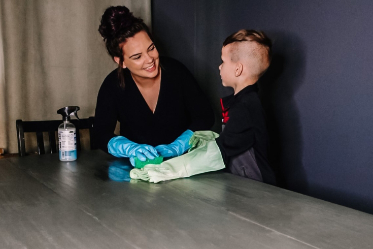 Brogan Ingram and her son cleaning a table