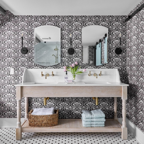 A modern farmhouse double vanity in a bathroom with charcoal grey and white floral wallpaper shown in the Home Network gallery Unusual Bathroom Renovation Ideas That Will Be Popular In 2025