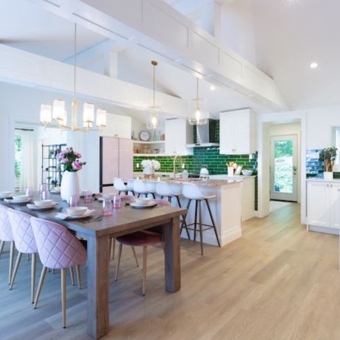 dining room with wood floors, kitchen, windows, light fixtures