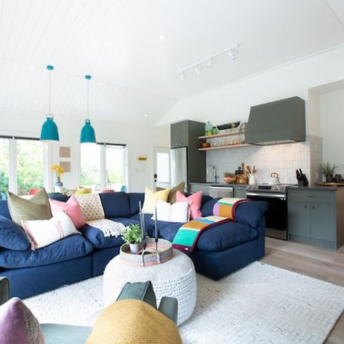 living room and kitchen with plush couches and coffee table