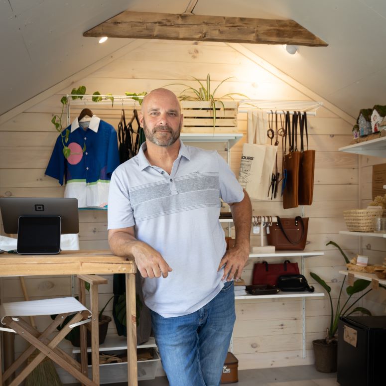 Bryan Baeumler in a farmer's market stand