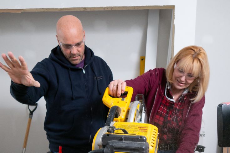Bryan and Joanne working together on a saw