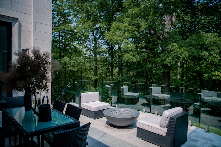 Outdoor deck and seating area with trees for privacy
