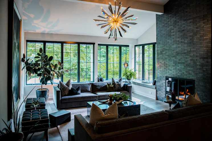 Well lit sitting room with view of trees