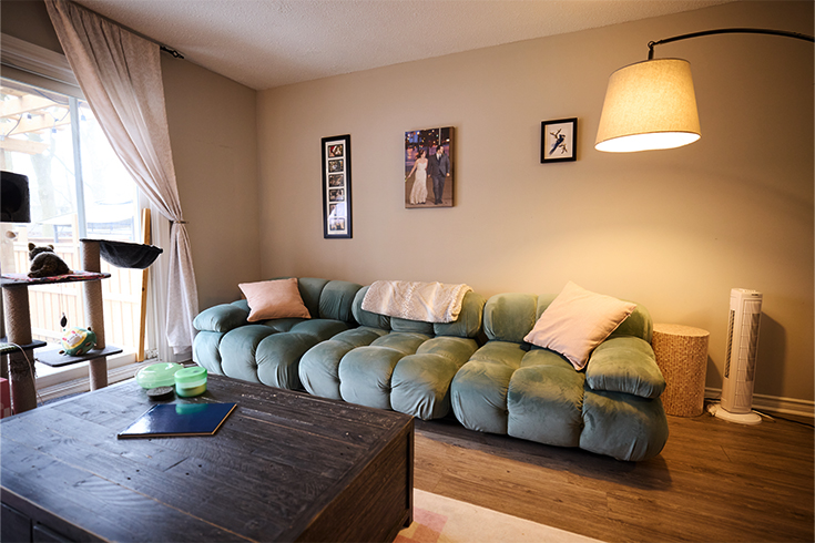 A picture of a living room with a large couch and black coffee table