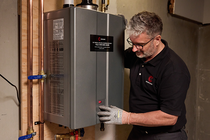 An Enercare professional installing a tankless hot water