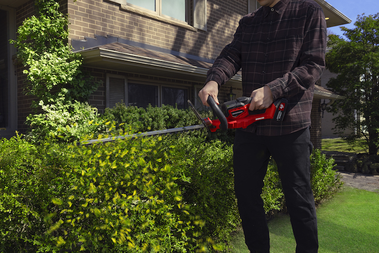 Man using trim hedger