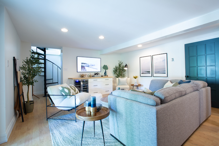 Lower level living room with bar fridge and TV