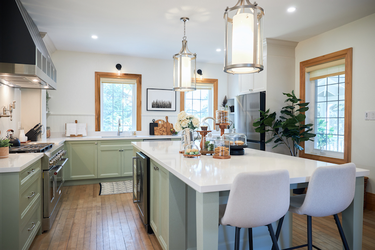 An updated Victorian kitchen with light green cabinets