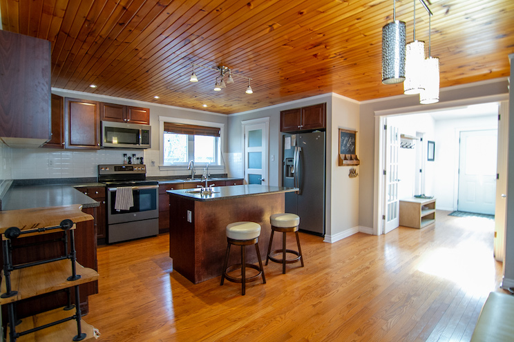 Kitchen with stainless steel appliances and wood finishes