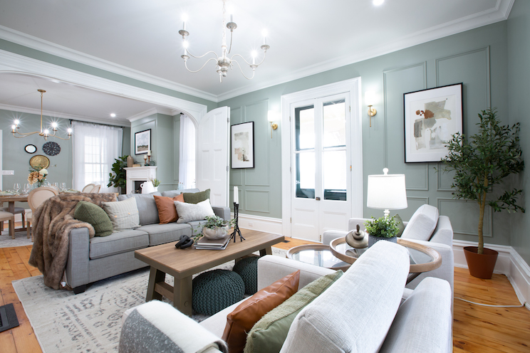 Upgraded farmhouse living room with blue walls and wainscotting