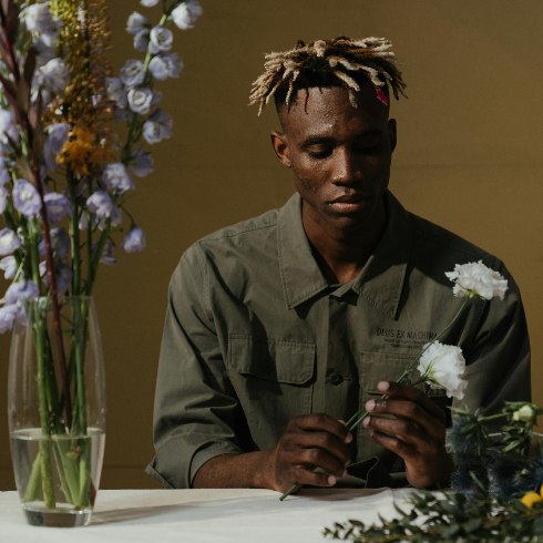 A man arranging a bouquet of fresh flowers