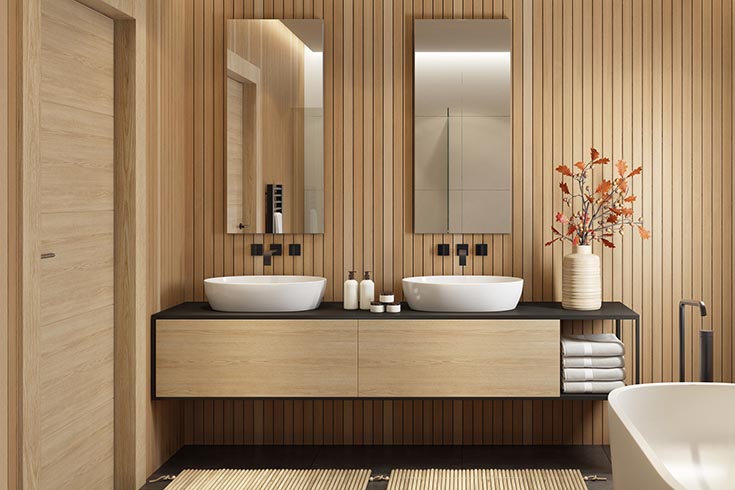 Luxurious bathroom with natural stone tiles and wooden cabinet. 