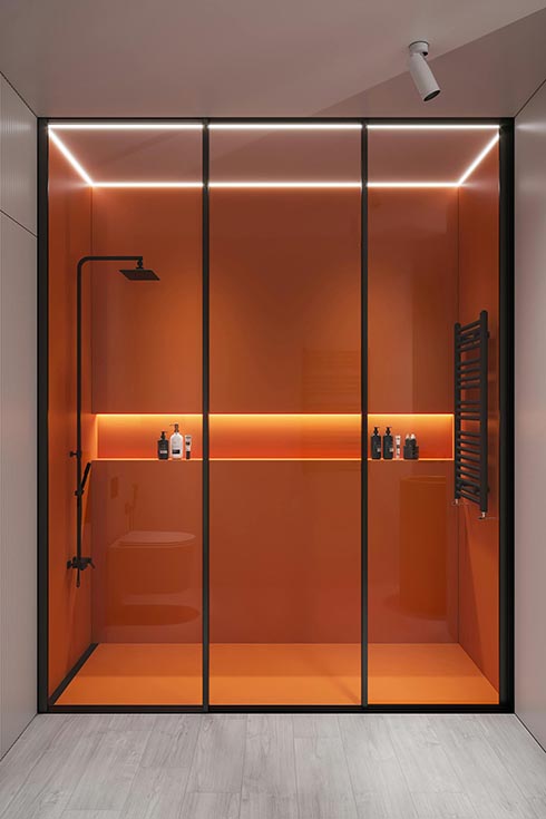 A modern shower enclosed with black-framed glass