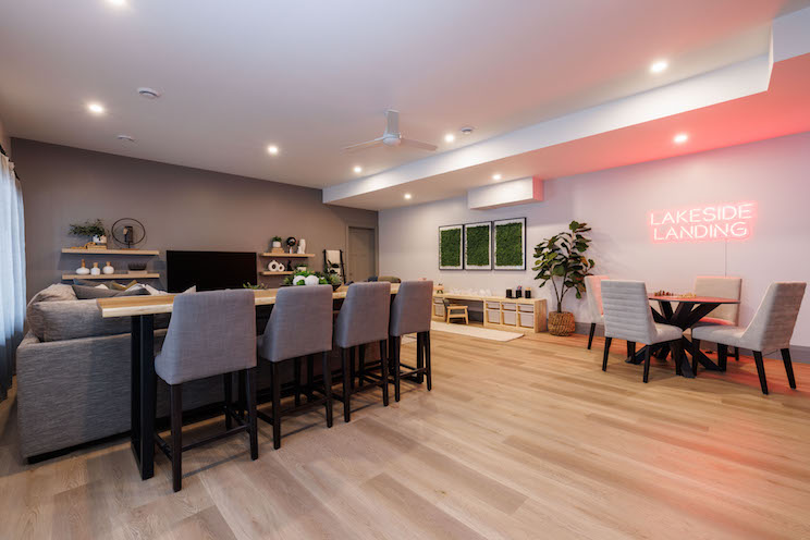Living space with neon 'Lakeside Landing' sign
