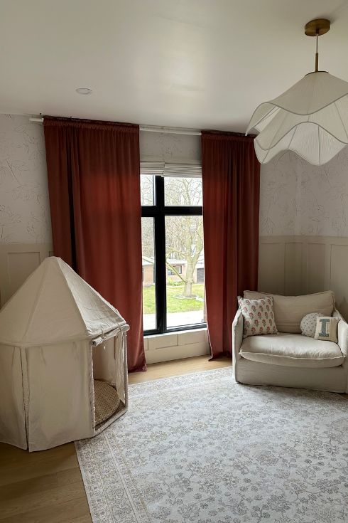 A children's nook and loveseat in the corner of a nursery