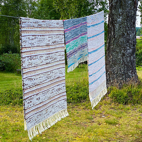 Rag rugs on clothes line in garden. Countryside. Rustic. Swedish summer.