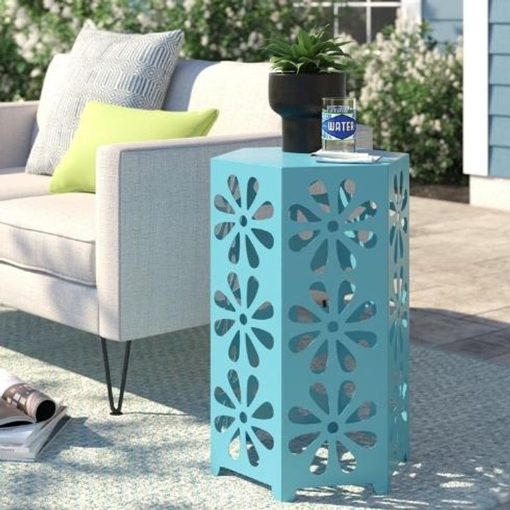 sun on rug outside patio with teal table and book