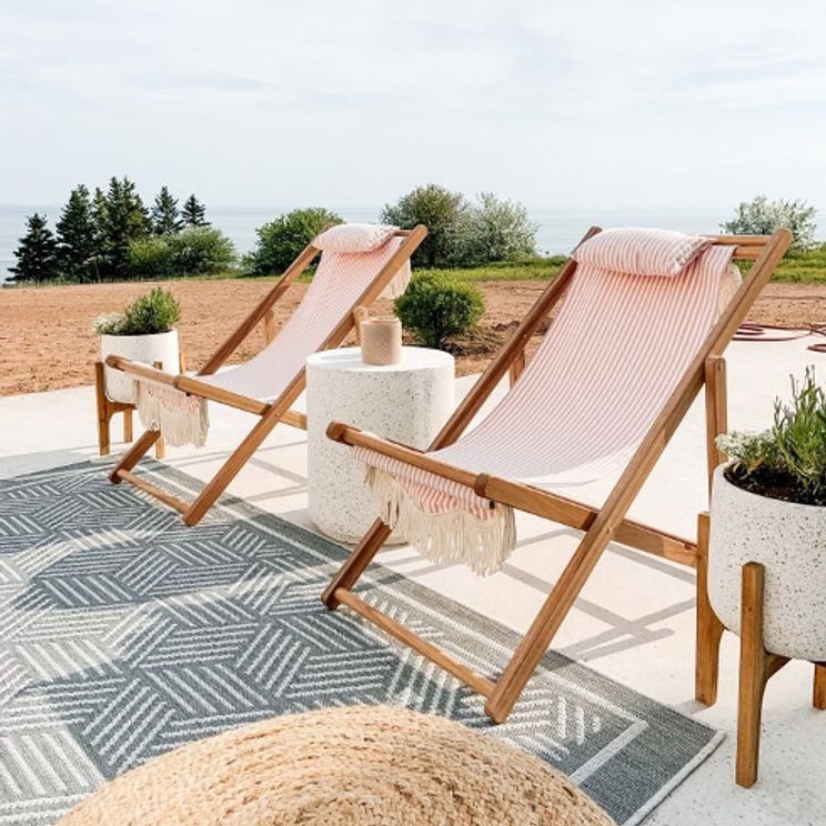 pink chairs on rug outside