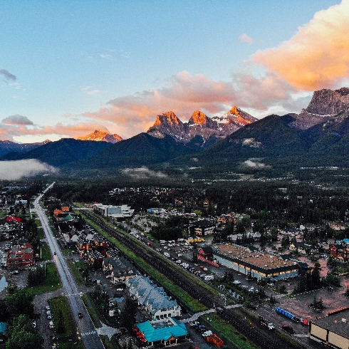 An aerial view of Canmore, Alberta with mountains in the background.