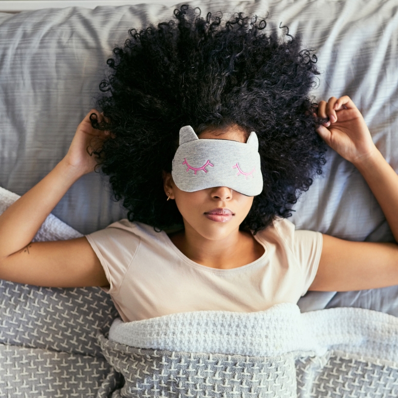 A young woman sleeping with her face mask on