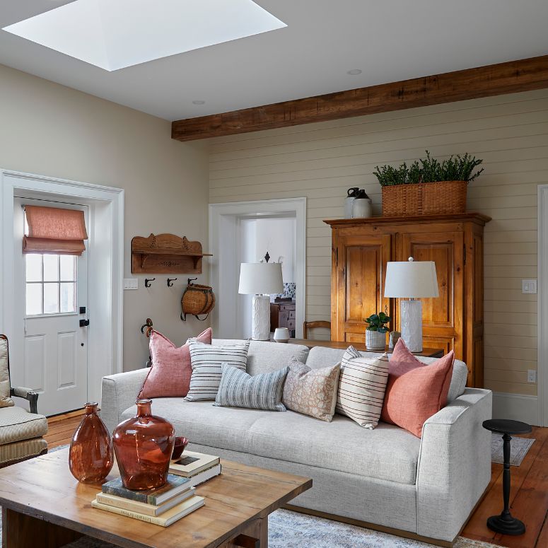 Living room with light couch and pink accents