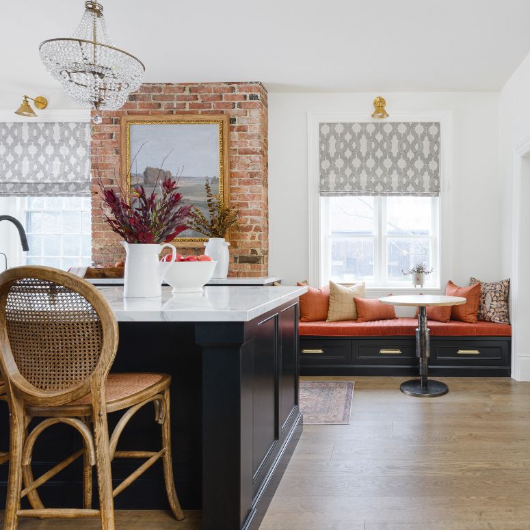 Bright kitchen with black counter, bay window and rustic accents