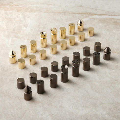 Blackened and Polished Brass Chess Set from CB2 sits on a beige marble countertop as part of HGTV Canada's 10 Gift Ideas for the Men in Your Life