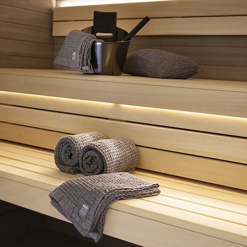 Harvia by Luhta Sauna Towel and other accessories sit on the wooden benches of a Finnish sauna as part of HGTV Canada's 10 Gift Ideas for the Men in Your Life