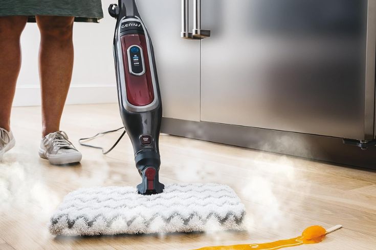 Someone using the Shark steam mop on a spill in the kitchen