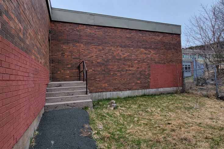 The drab and neglected exterior of a school