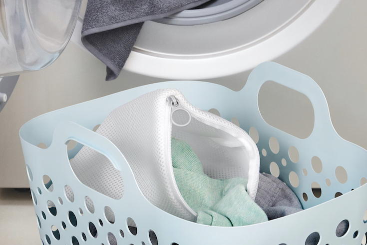Ikea Slibb Laundry Bags in a blue laundry basket as featured in Laundry Mistakes on HGTV Canada