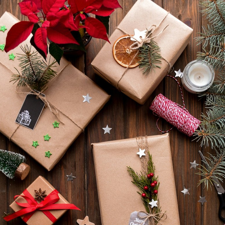 Christmas gifts for Home Network More Sustainable Holidays featuring presents wrapped in brown paper, jute twine, twigs and orange slices