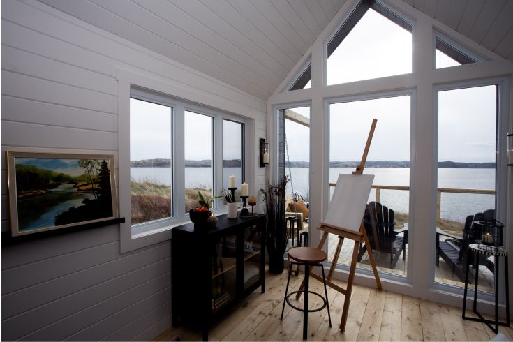Simple white interior of the cliffside artist pod