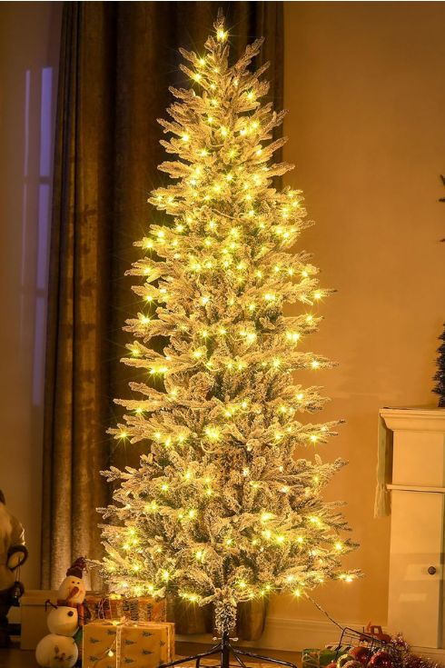 Artificial christmas tree lit up in living room
