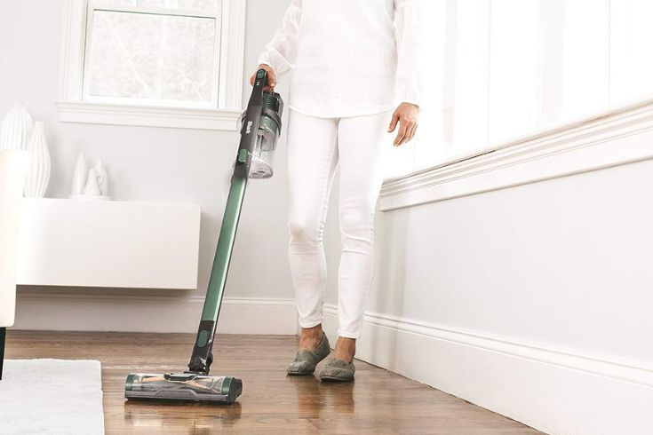 Woman using the Shark IZ140C Rocket Pro Lightweight Cordless Stick Vacuum