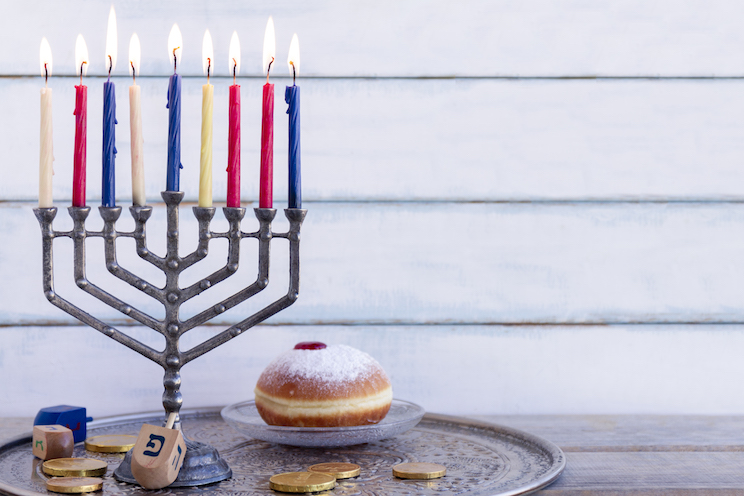 Colourful menorah and a donut